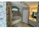 Bathroom featuring a shower, a bathtub with tile surround, a sink, and floral wallpaper at 16 Hunt Master Ct, Ormond Beach, FL 32174