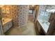 Bathroom with double vanities, floral wallpaper, and carpeted floor at 16 Hunt Master Ct, Ormond Beach, FL 32174