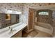 Bathroom with floral wallpaper, double sinks, shower, and a large soaking tub at 16 Hunt Master Ct, Ormond Beach, FL 32174