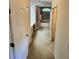 Hallway to a bathroom featuring floral wallpaper, carpet flooring, and a shower at 16 Hunt Master Ct, Ormond Beach, FL 32174
