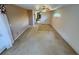Large carpeted bedroom with tray ceiling, fan, and access to the bath and closet at 16 Hunt Master Ct, Ormond Beach, FL 32174