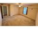 This carpeted bedroom features a ceiling fan, closet, window, and overhead shelving at 16 Hunt Master Ct, Ormond Beach, FL 32174