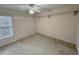 Unfurnished bedroom with a ceiling fan, window, overhead shelf and carpeting ready for decor at 16 Hunt Master Ct, Ormond Beach, FL 32174