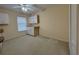 Bright bedroom featuring neutral paint, carpet, ceiling fan, and built-in storage space near a window at 16 Hunt Master Ct, Ormond Beach, FL 32174