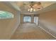 Spacious bedroom featuring a ceiling fan, neutral walls, and a large window for plenty of natural light at 16 Hunt Master Ct, Ormond Beach, FL 32174