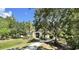 Community clubhouse with sidewalk surrounded by mature trees at 16 Hunt Master Ct, Ormond Beach, FL 32174