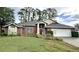 Charming single-story brick home with a well-manicured lawn and beautiful landscaping at 16 Hunt Master Ct, Ormond Beach, FL 32174