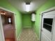 This hallway area has green walls, patterned flooring, cabinet, and doors at 16 Hunt Master Ct, Ormond Beach, FL 32174