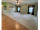 Open living area with neutral carpet, large windows, and views into the adjacent kitchen at 16 Hunt Master Ct, Ormond Beach, FL 32174