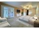 Beautiful Primary bedroom with private backyard access, bed, tv, chairs, and modern furnishings at 16 Hunt Master Ct, Ormond Beach, FL 32174