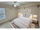 This staged main bedroom offers warm natural light, comfortable decor and overhead shelving at 16 Hunt Master Ct, Ormond Beach, FL 32174