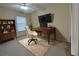 Bright office space with a large desk, chair, bookshelf, area rug, and mounted television at 16 Hunt Master Ct, Ormond Beach, FL 32174