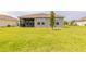 Expansive backyard with lush green grass and a screened-in patio, perfect for outdoor living and entertaining at 2840 Monaghan Dr, Ormond Beach, FL 32174