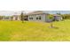 Spacious backyard featuring lush green grass and a view of the lake from the lanai at 2840 Monaghan Dr, Ormond Beach, FL 32174