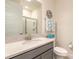 Bathroom featuring granite counters, modern sink, vanity and toilet with beach themed decorations at 2840 Monaghan Dr, Ormond Beach, FL 32174
