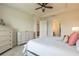 Bright bedroom featuring soft carpet, tray ceiling, ceiling fan, and ample storage space at 2840 Monaghan Dr, Ormond Beach, FL 32174