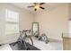 Functional bedroom with a ceiling fan, window, and home gym equipment at 2840 Monaghan Dr, Ormond Beach, FL 32174