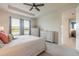 Bedroom featuring a tray ceiling, ceiling fan, two dressers and soft natural light at 2840 Monaghan Dr, Ormond Beach, FL 32174