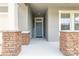 Charming entryway with a blue front door, brick pillars and a glimpse into a well-lit interior at 2840 Monaghan Dr, Ormond Beach, FL 32174