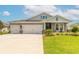 Charming one-story home featuring a three-car garage, well-manicured lawn and decorative brick pillars at 2840 Monaghan Dr, Ormond Beach, FL 32174