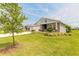 Beautiful single-story home with lush green lawn, mature trees, and three-car garage in a lovely neighborhood at 2840 Monaghan Dr, Ormond Beach, FL 32174