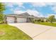 Street view of a well-manicured lawn with a house that has a three-car garage and gray color palette at 2840 Monaghan Dr, Ormond Beach, FL 32174