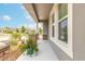 Inviting front porch with decorative brick pillars, potted plants, and view of manicured landscaping at 2840 Monaghan Dr, Ormond Beach, FL 32174