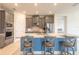 Modern kitchen island with quartz countertops, barstool seating, stainless appliances and gray cabinets at 2840 Monaghan Dr, Ormond Beach, FL 32174