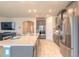 Kitchen island with stainless appliances, gray cabinetry, quartz countertops and an open concept living area at 2840 Monaghan Dr, Ormond Beach, FL 32174