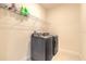 Laundry room featuring a gray washer and dryer with storage shelf at 2840 Monaghan Dr, Ormond Beach, FL 32174