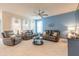 Bright living room featuring tile floors, three sofas, ceiling fan, and blue accent wall at 2840 Monaghan Dr, Ormond Beach, FL 32174