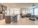 Open concept living room featuring breakfast bar, chairs, ceiling fan, and leather sofas at 2840 Monaghan Dr, Ormond Beach, FL 32174