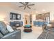 Open living area showcasing modern furnishings, a kitchen island, and an entertainment center with a fireplace at 2840 Monaghan Dr, Ormond Beach, FL 32174
