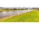 Scenic view of the tranquil pond, enhancing the property's appeal with its serene water feature and fountain at 2840 Monaghan Dr, Ormond Beach, FL 32174