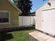 View of backyard featuring home, detached storage building, and privacy fence at 543 Sandy Oaks Blvd, Ormond Beach, FL 32174