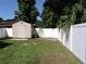 Fenced backyard featuring a shed and lush green lawn at 543 Sandy Oaks Blvd, Ormond Beach, FL 32174
