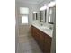 Bathroom features double sinks, wood cabinets, and a tiled floor at 543 Sandy Oaks Blvd, Ormond Beach, FL 32174