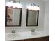 Bathroom featuring a double sink vanity with framed mirrors and modern fixtures at 543 Sandy Oaks Blvd, Ormond Beach, FL 32174