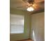 Bright bedroom features built-in storage, a window with blinds, and a ceiling fan at 543 Sandy Oaks Blvd, Ormond Beach, FL 32174