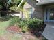 Landscaped front yard with manicured plants and a small palm tree at 543 Sandy Oaks Blvd, Ormond Beach, FL 32174