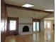 Inviting living room featuring a brick fireplace, beamed ceiling, and hardwood floors at 543 Sandy Oaks Blvd, Ormond Beach, FL 32174