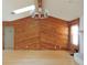 Bright living room boasts wood paneled walls, hardwood floors, and a modern chandelier at 543 Sandy Oaks Blvd, Ormond Beach, FL 32174