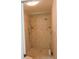Walk-in shower with dual showerheads and travertine tile at 543 Sandy Oaks Blvd, Ormond Beach, FL 32174