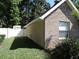 Well-kept yard next to brick house and white privacy fence at 543 Sandy Oaks Blvd, Ormond Beach, FL 32174