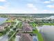 Aerial view of a lakeside neighborhood with well-maintained homes and inviting pool areas at 568 Luna Bella Ln, New Smyrna Beach, FL 32168