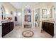 Elegant bathroom features dual vanities, decorative tile flooring, a walk-in shower, and a separate toilet room at 568 Luna Bella Ln, New Smyrna Beach, FL 32168