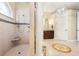 Bright bathroom with a walk-in shower, mosaic tile accents, and dual vanity with dark wood cabinets at 568 Luna Bella Ln, New Smyrna Beach, FL 32168