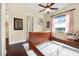 Bedroom with dark wood floors, light walls, and decorative art at 568 Luna Bella Ln, New Smyrna Beach, FL 32168