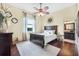 Bright bedroom with wood floors, dark wood furniture, and natural light at 568 Luna Bella Ln, New Smyrna Beach, FL 32168
