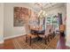 Formal dining room with coffered ceiling, picturesque mural and a grand chandelier over the dining table at 568 Luna Bella Ln, New Smyrna Beach, FL 32168